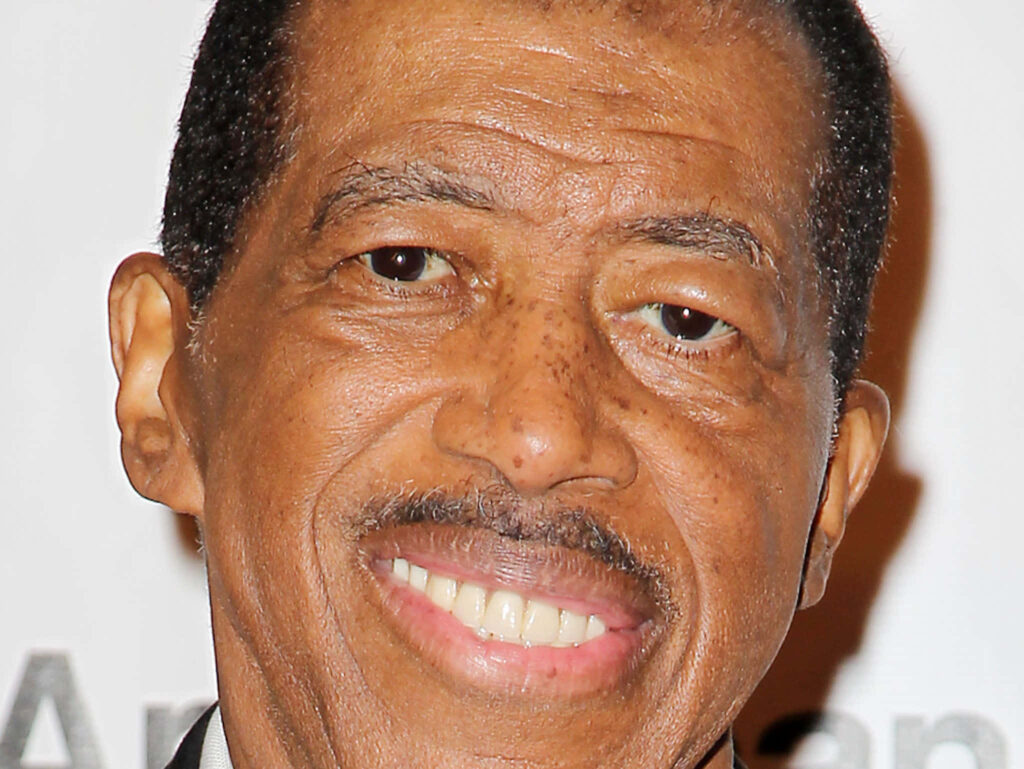 Close-up of soul singer Ben E King smiling warmly with a softly blurred background wallpaper