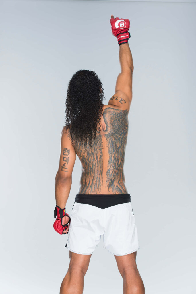 American MMA fighter Ben Henderson in Bellator photoshoot displaying iconic back tattoo and stance Wallpaper
