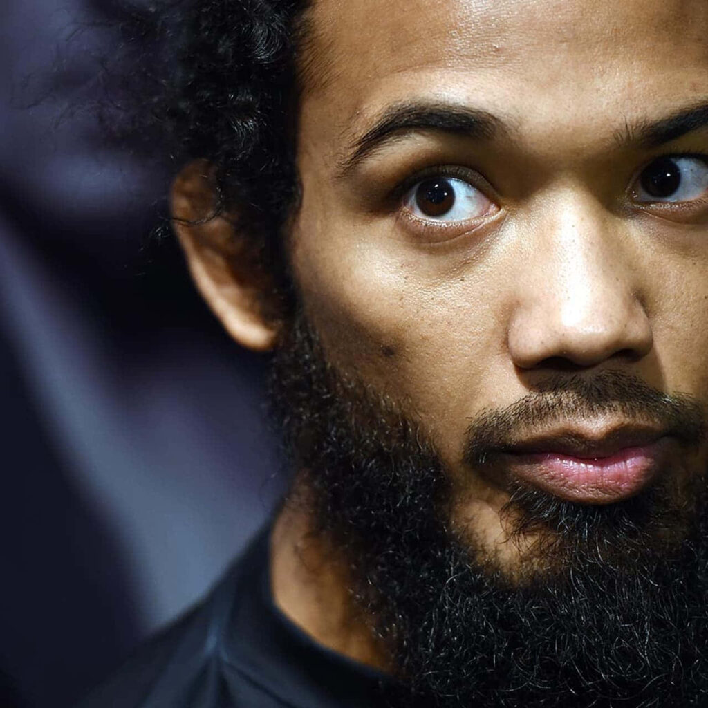 Close-up of MMA fighter Ben Henderson with intense gaze and distinctive beard wallpaper background