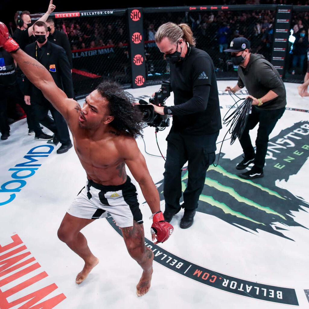 American MMA fighter Ben Henderson celebrates victory in ring showing energy and determination Wallpaper