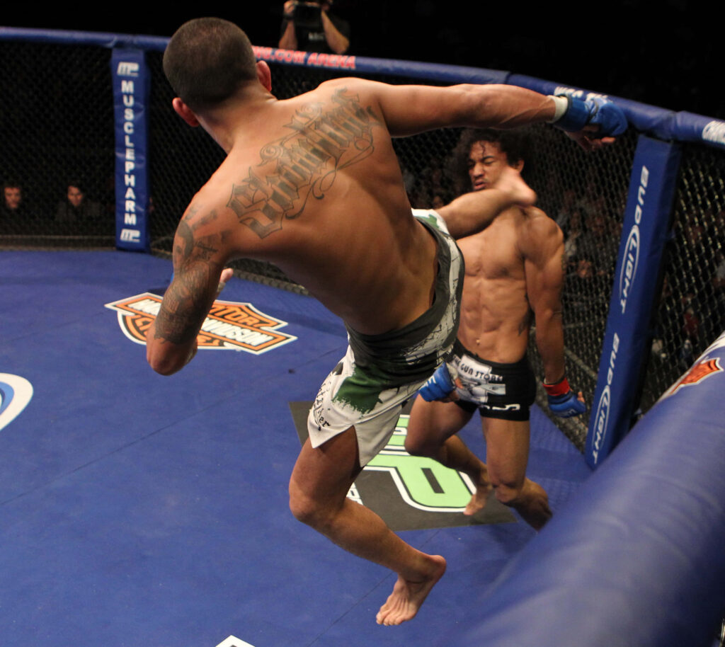 Ben Henderson vs Anthony Pettis MMA fight intense moment flying kick in octagon wallpaper background
