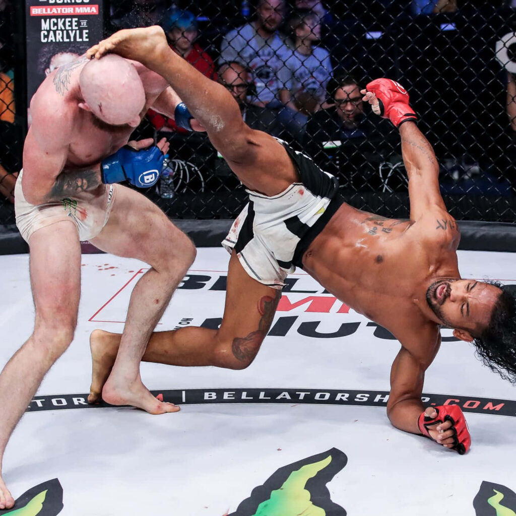 Ben Henderson delivers dynamic kick against Peter Queally in intense Bellator MMA match cage action Wallpaper