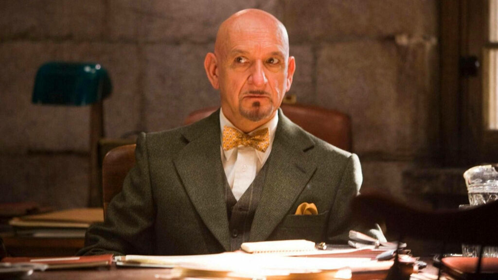 Ben Kingsley as John Cawley in Shutter Island intense expression behind desk psychological thriller Wallpaper