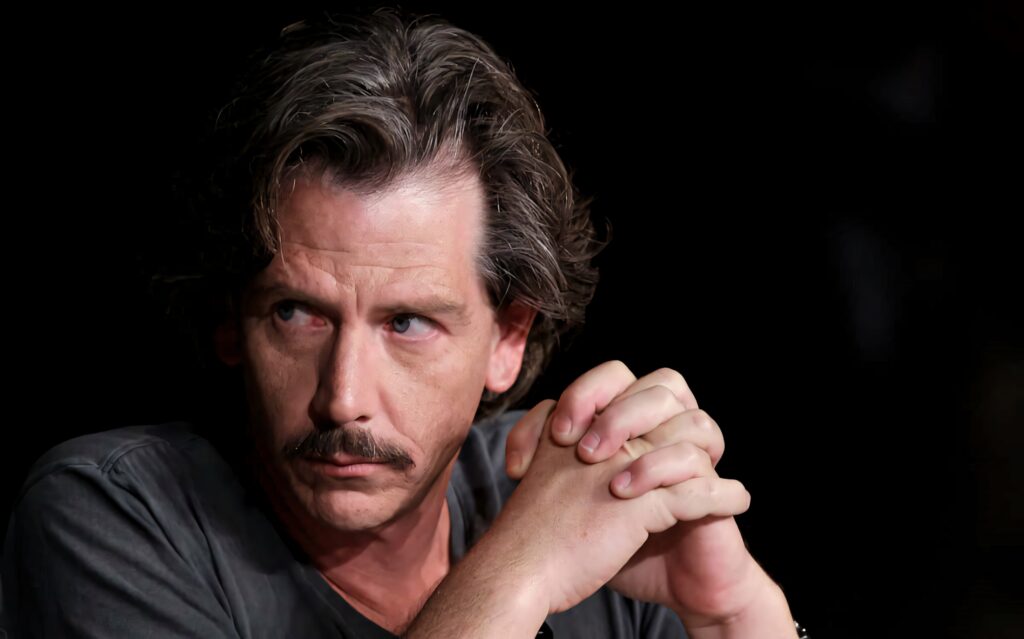 Ben Mendelsohn intense gaze portrait wallpaper with thoughtful expression on dark background