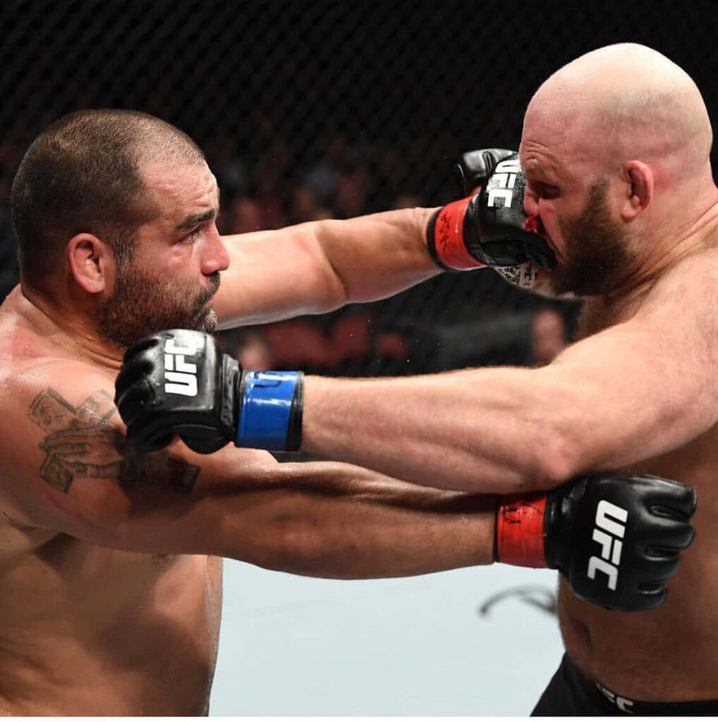 Ben Rothwell and Blagoy Ivanov exchanging powerful punches in intense UFC mixed martial arts fight Wallpaper