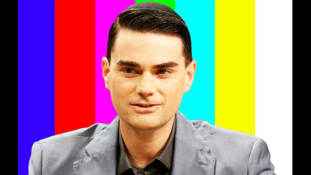 Ben Shapiro standing against vibrant colorful test pattern background blackout screen wallpaper
