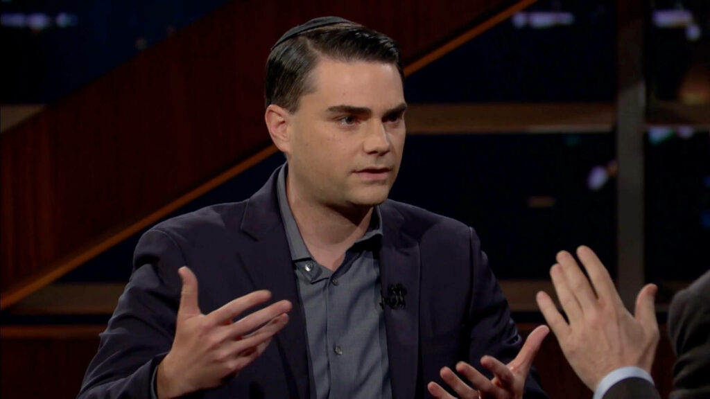 Ben Shapiro serious discussion wearing dark suit jacket kippah interview studio backdrop wallpaper