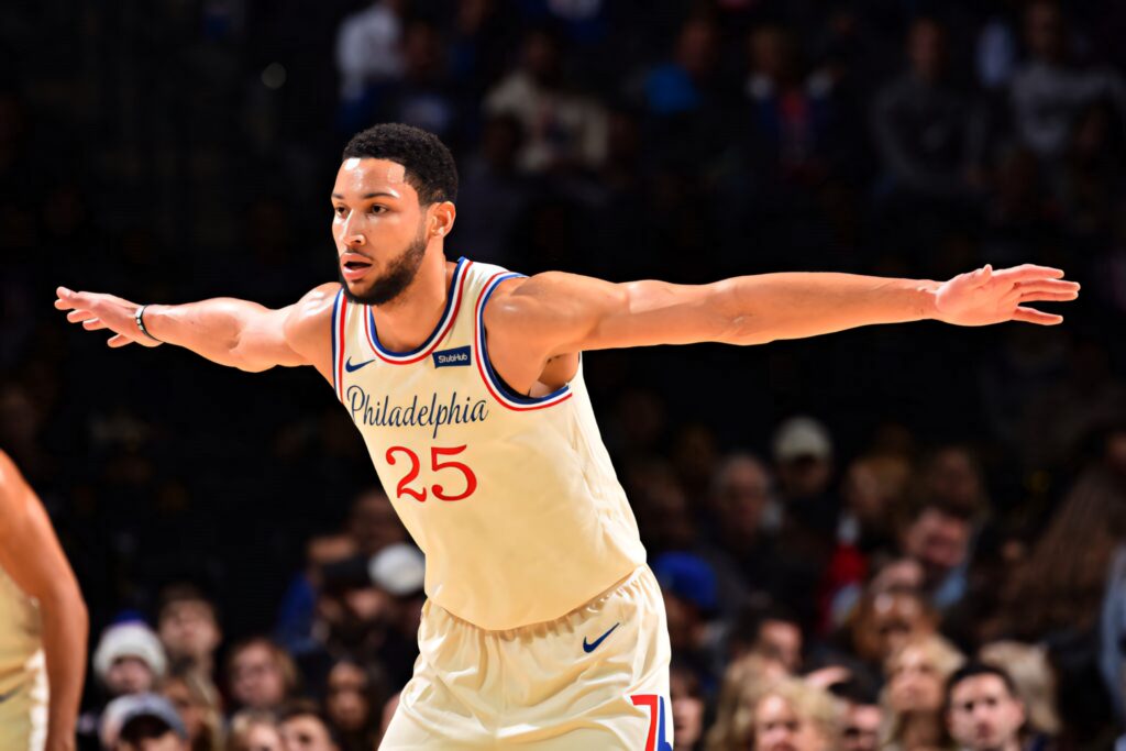 Ben Simmons defensive stance Philadelphia 76ers intense basketball game action wallpaper background