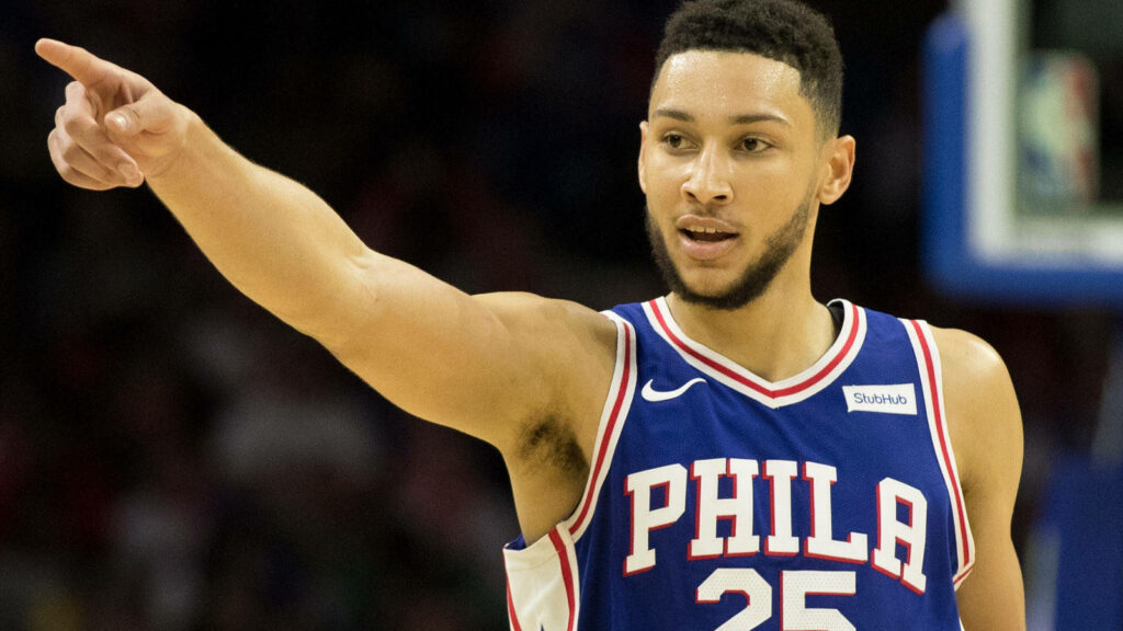 Ben Simmons in Philadelphia 76ers jersey pointing confidently on court dynamic basketball wallpaper