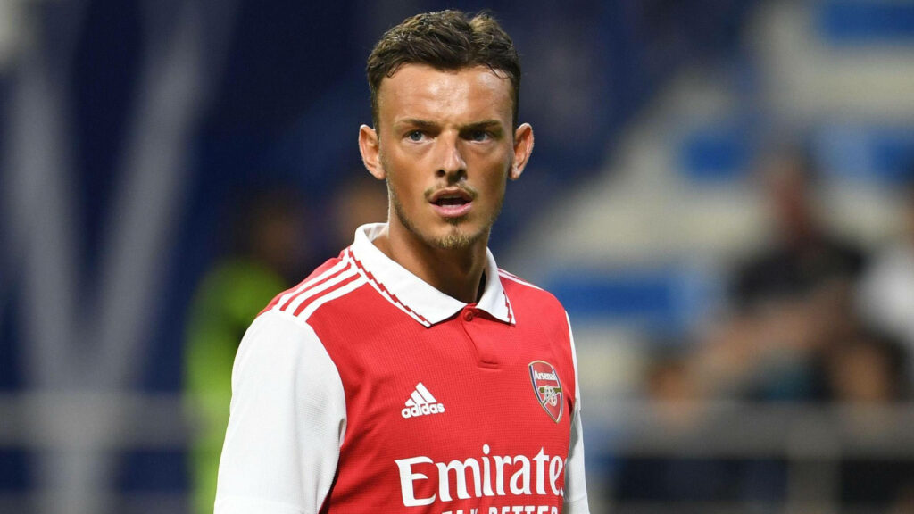 Close-up portrait of Ben White in Arsenal jersey showing focused expression during football match Wallpaper