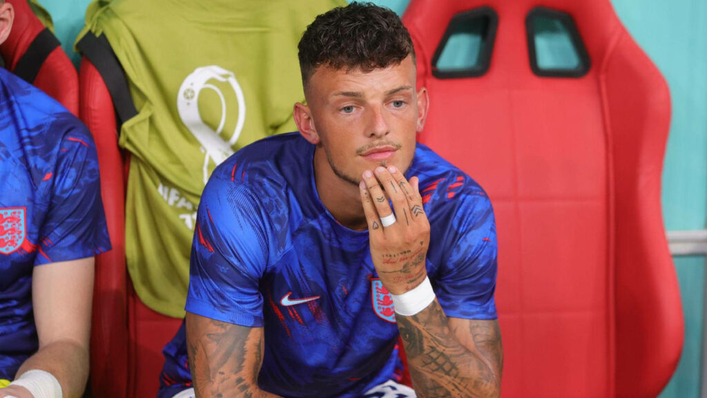 Ben White in England football kit sitting on bench reflecting match intensity and anticipation Wallpaper