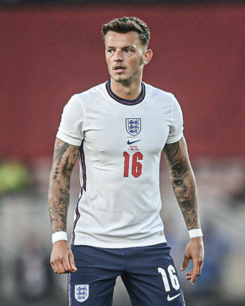 Ben White in white England kit number 16 focused during match action on football field wallpaper