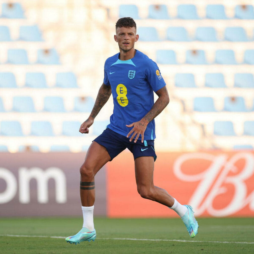 Ben White in England blue training kit practicing on empty stadium field during session Wallpaper