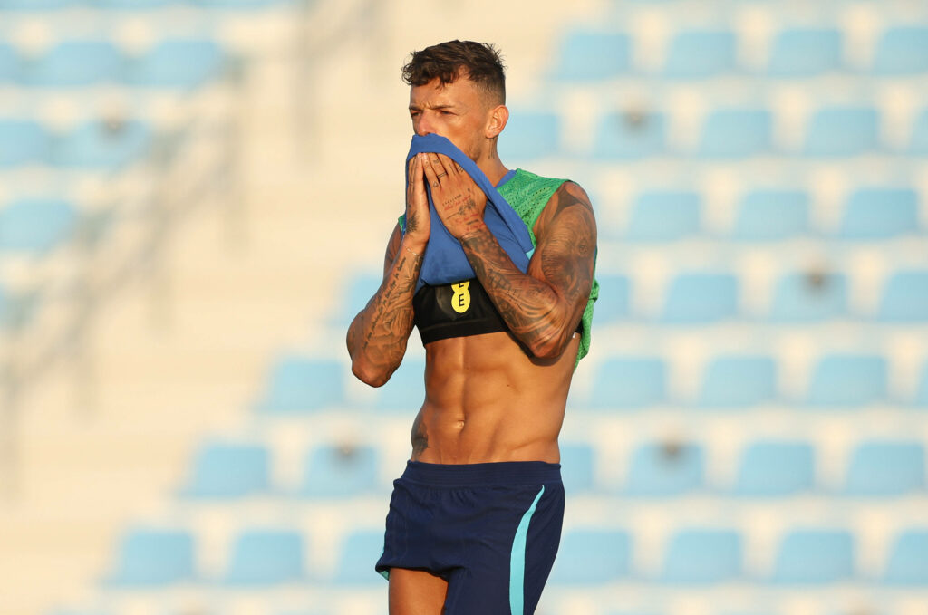 Ben White wiping sweat with shirt during intense football training session showing focus and determination Wallpaper