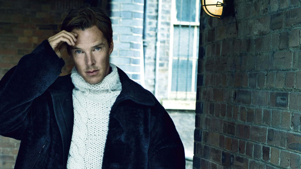 Benedict Cumberbatch in white sweater and dark coat against rustic brick wall stylish wallpaper