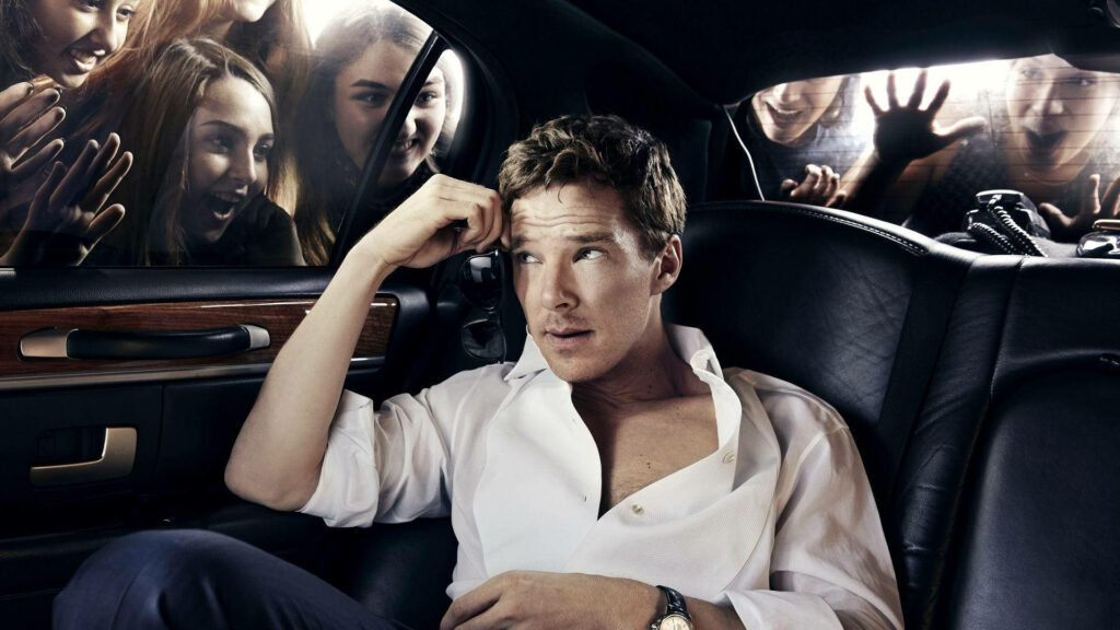 Benedict Cumberbatch relaxing in car backseat with excited fans outside window wallpaper background
