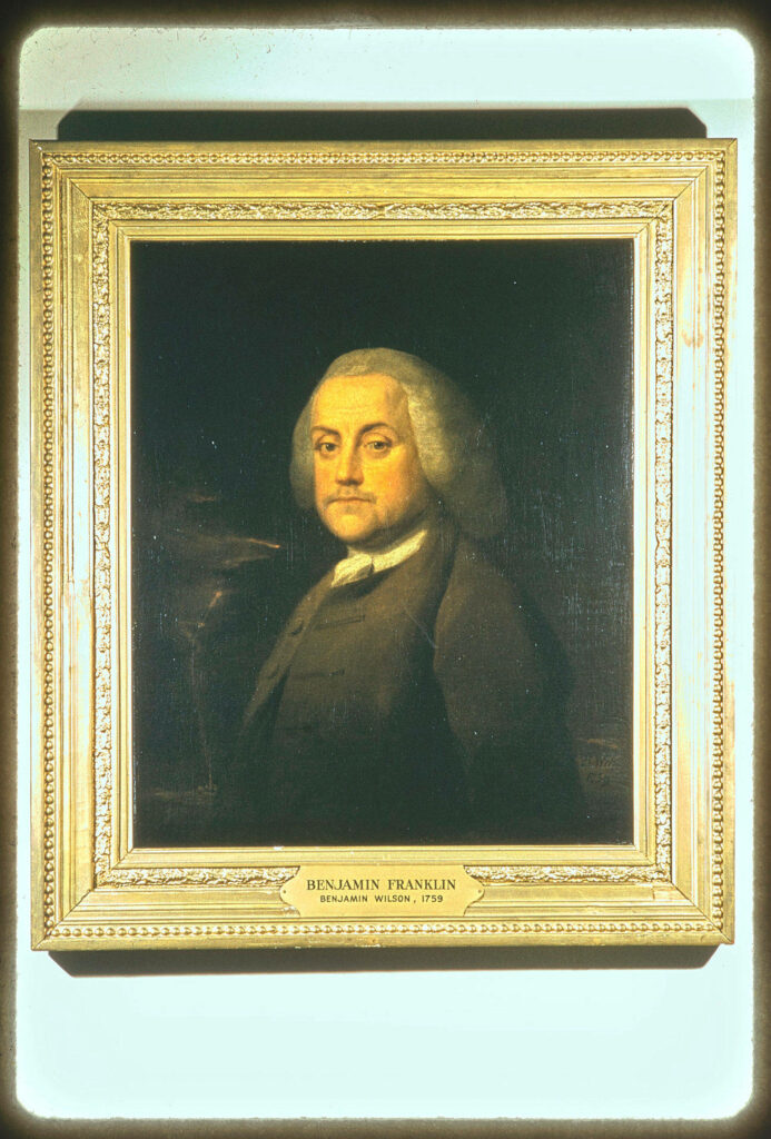 Classic Benjamin Franklin portrait in ornate gold frame by artist Benjamin Wilson wallpaper background