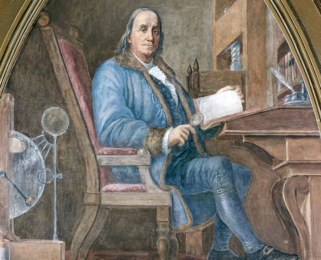 Benjamin Franklin portrait at desk with scientific instruments statesman inventor wallpaper background