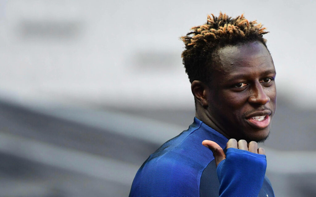 Benjamin Mendy in blue athletic top pointing to his back candid portrait blurred background wallpaper