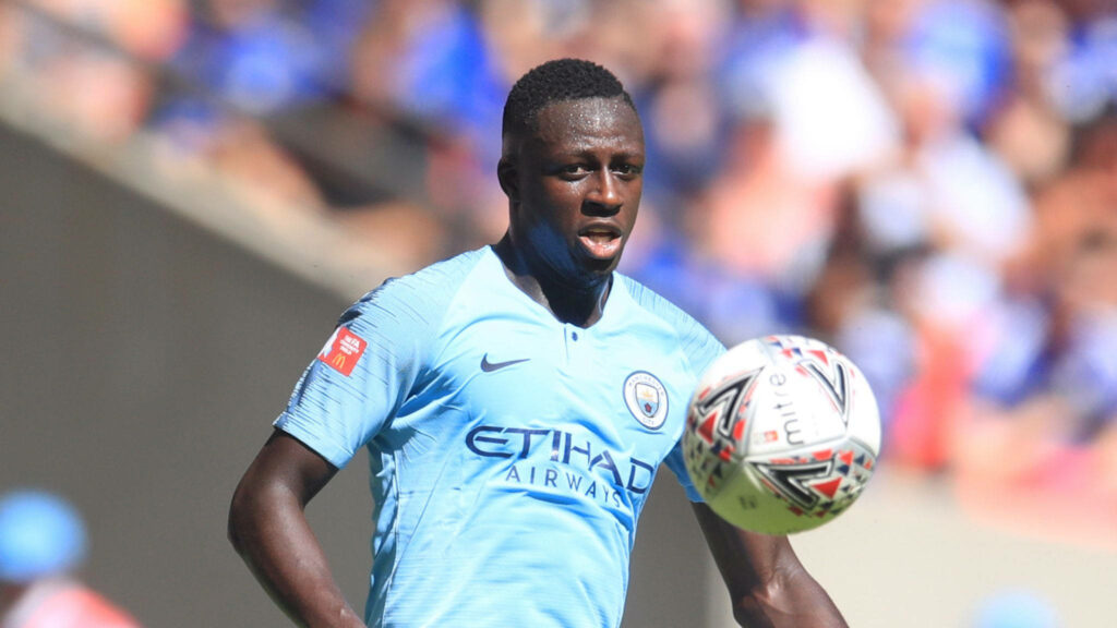 Benjamin Mendy playing football in Manchester City kit controlling ball on field action wallpaper background