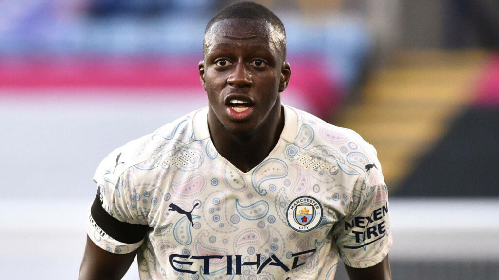 Benjamin Mendy in Manchester City kit with club logo dynamic football wallpaper background
