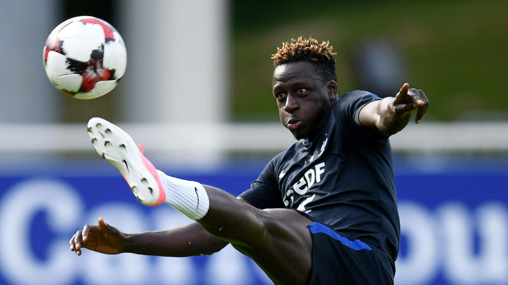 Benjamin Mendy kicking soccer ball during intense training session showing athletic skill and focus Wallpaper