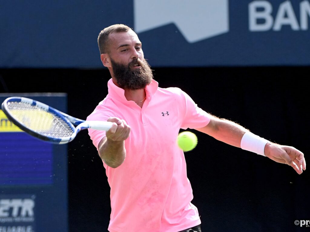 Benoît Paire tennis player in neon pink shirt focused on forehand shot on court wallpaper background