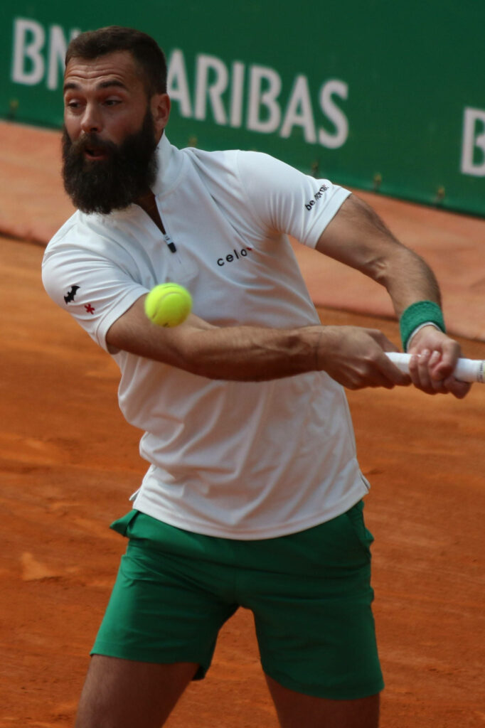 Benoît Paire intense backhand shot on clay court professional tennis action wallpaper background