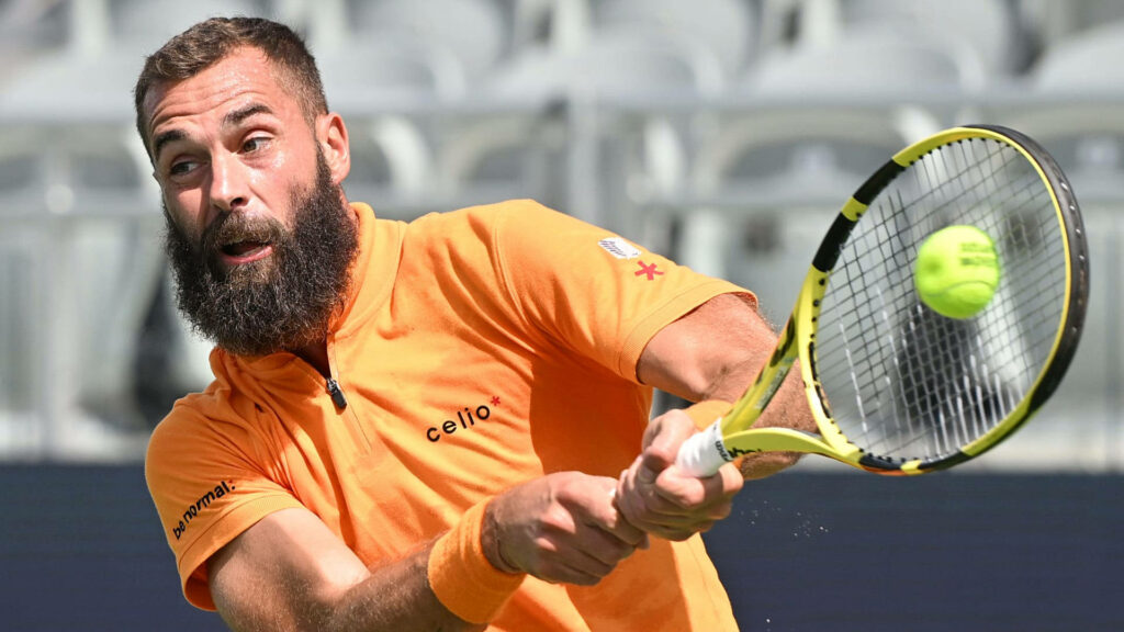 Professional tennis player Benoît Paire hitting powerful backhand shot during intense match play Wallpaper