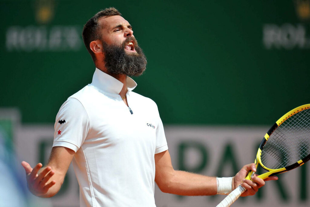 Benoit Paire celebrates passionately with arms open on tennis court during intense match wallpaper