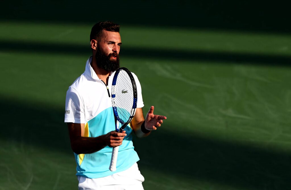 Benoît Paire on tennis court holding racquet passionately talking during intense match wallpaper