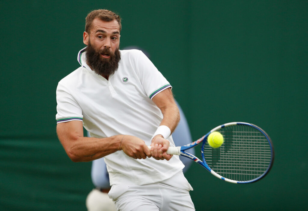 Benoît Paire hitting a powerful forehand on tennis court showcasing focus and athleticism Wallpaper