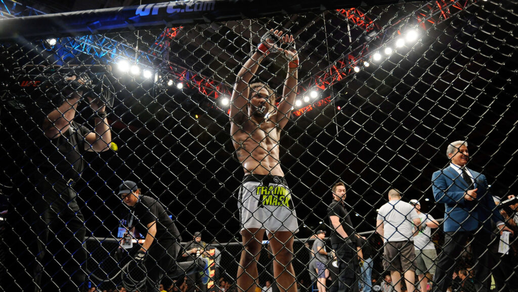 Benson Henderson victorious MMA fighter in ring bright lights cheering fans championship intensity Wallpaper