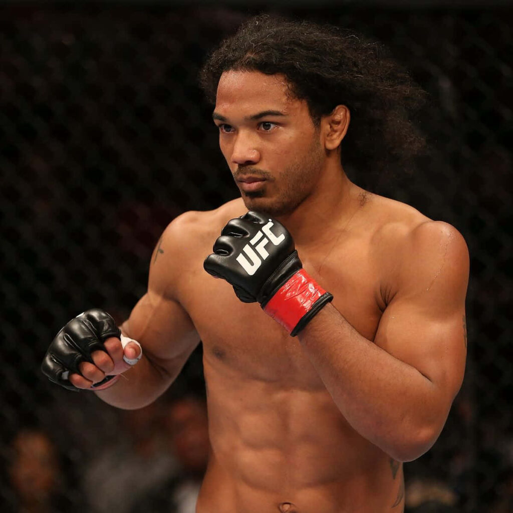MMA fighter Benson Henderson intense striking pose showcasing athleticism inside cage wallpaper