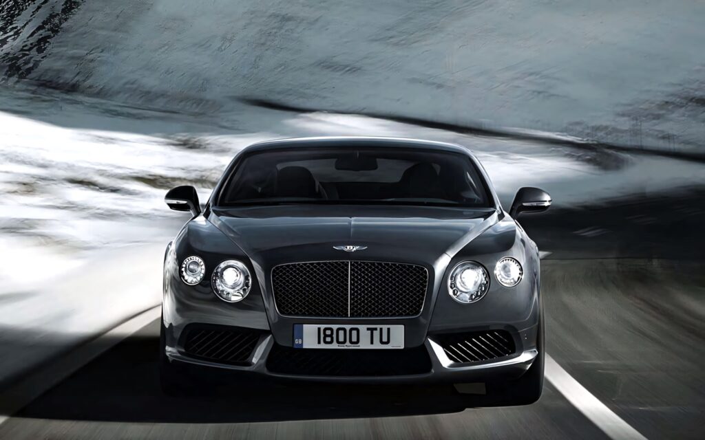 Bentley Sport luxury car wallpaper showing bold design and performance on open road background