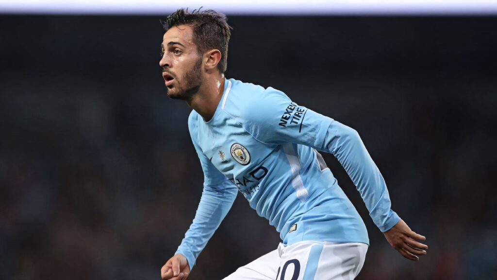 Bernardo Silva running left in Manchester City kit focused during intense football match wallpaper