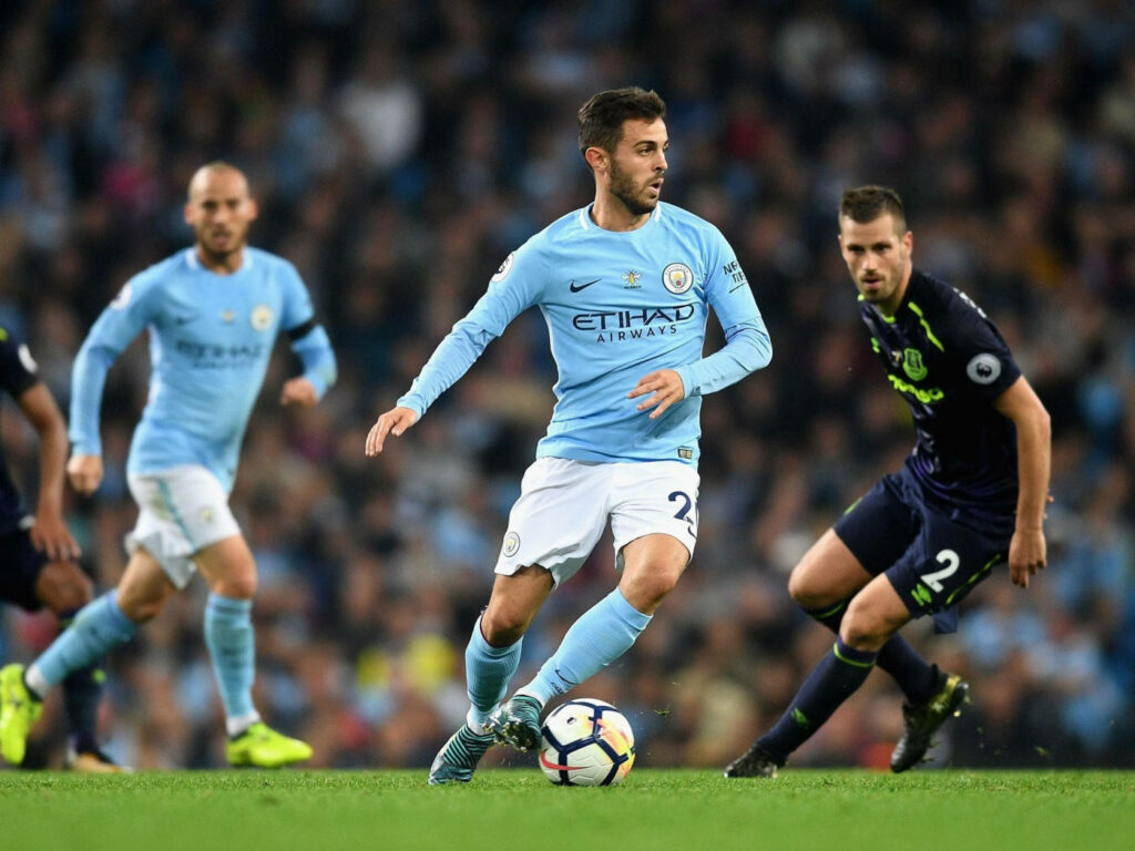 Bernardo Silva in blue Manchester City kit preparing to kick ball during intense football match wallpaper
