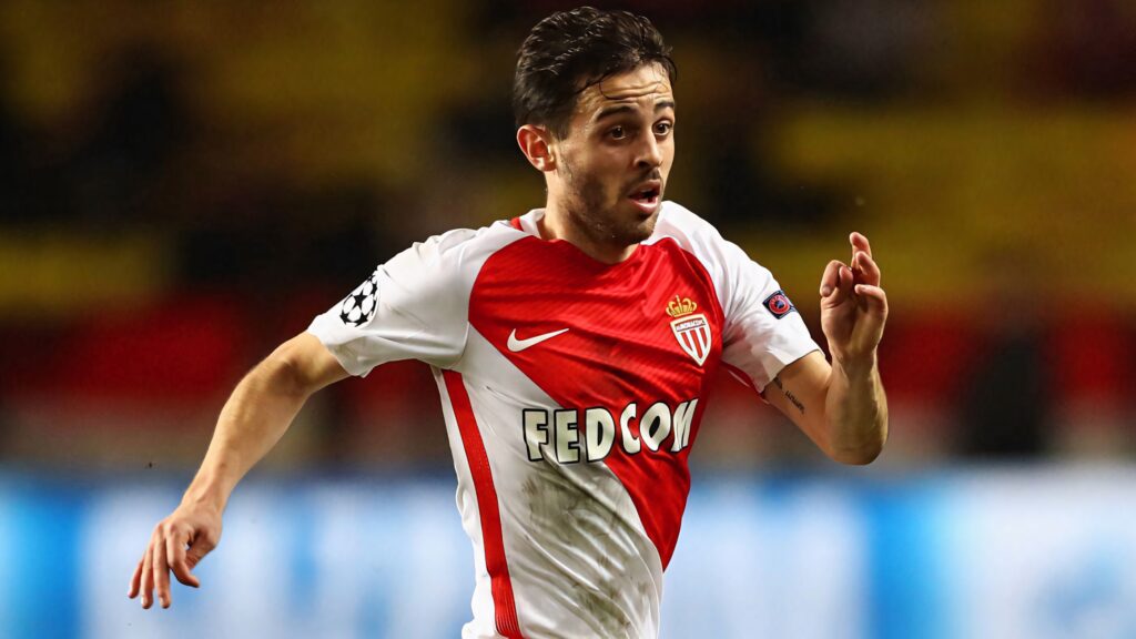 Bernardo Silva running on field wearing red and white Monaco football kit wallpaper background