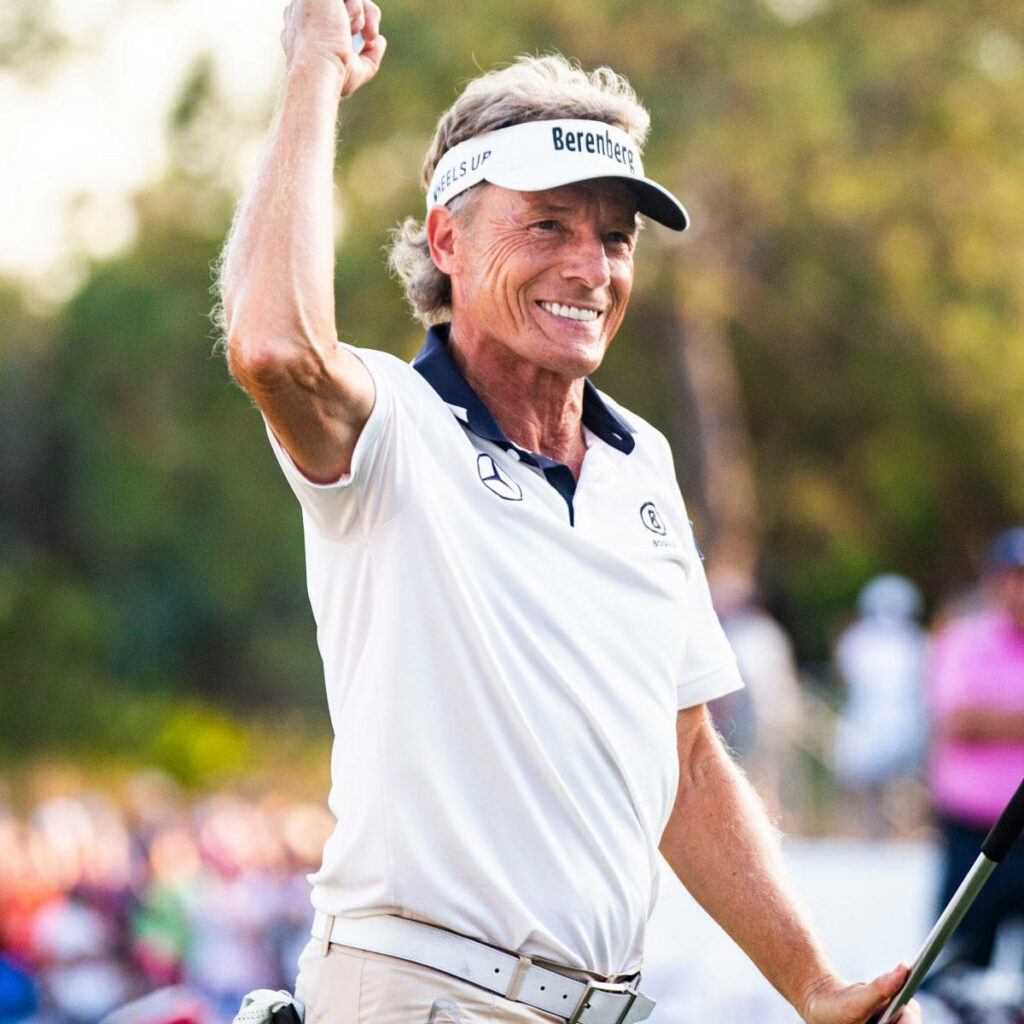 Bernhard Langer celebrating victory on golf course vibrant wallpaper background golf success