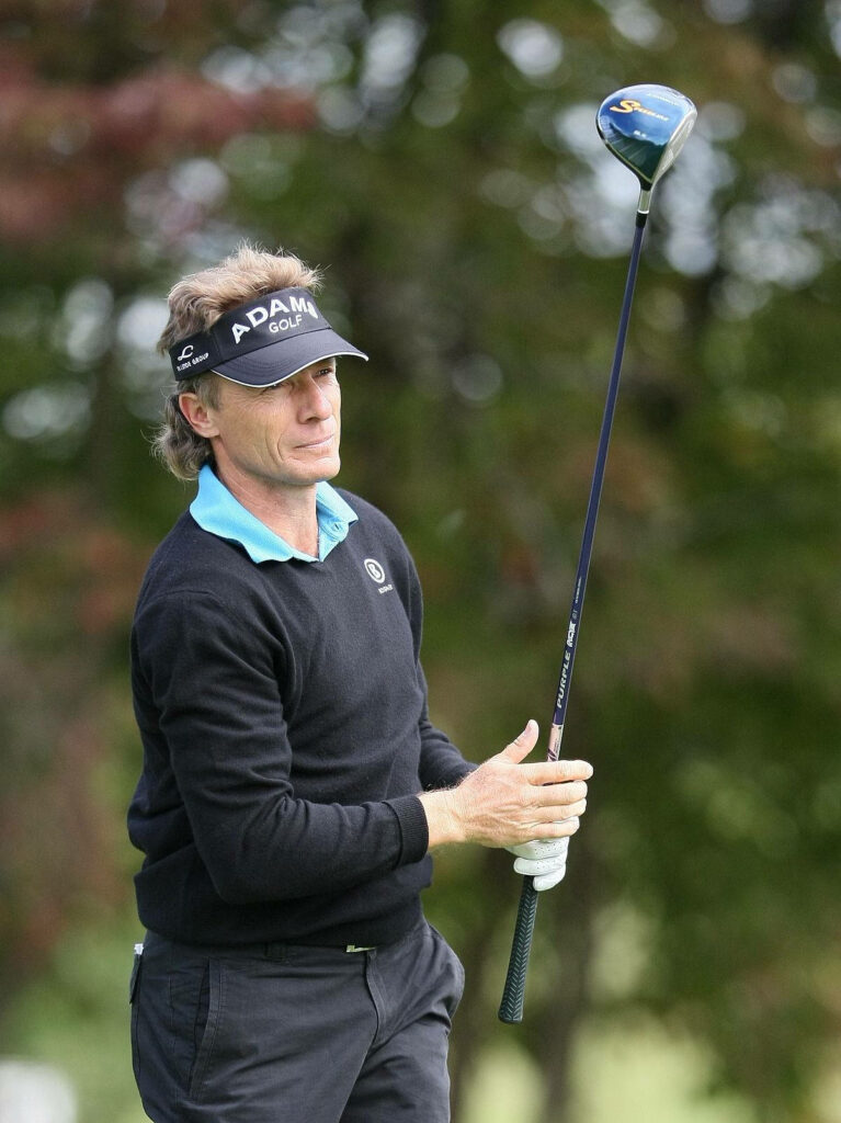 Bernhard Langer focused on golf course in all black outfit holding driver professional golfer Wallpaper