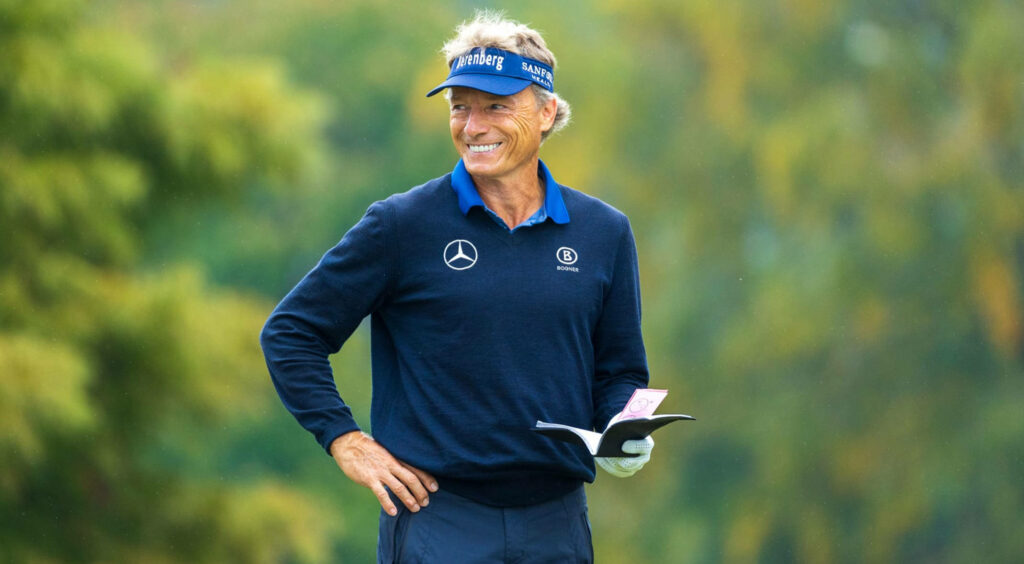 Bernhard Langer smiling confidently on golf course wearing signature golfing attire outdoors Wallpaper