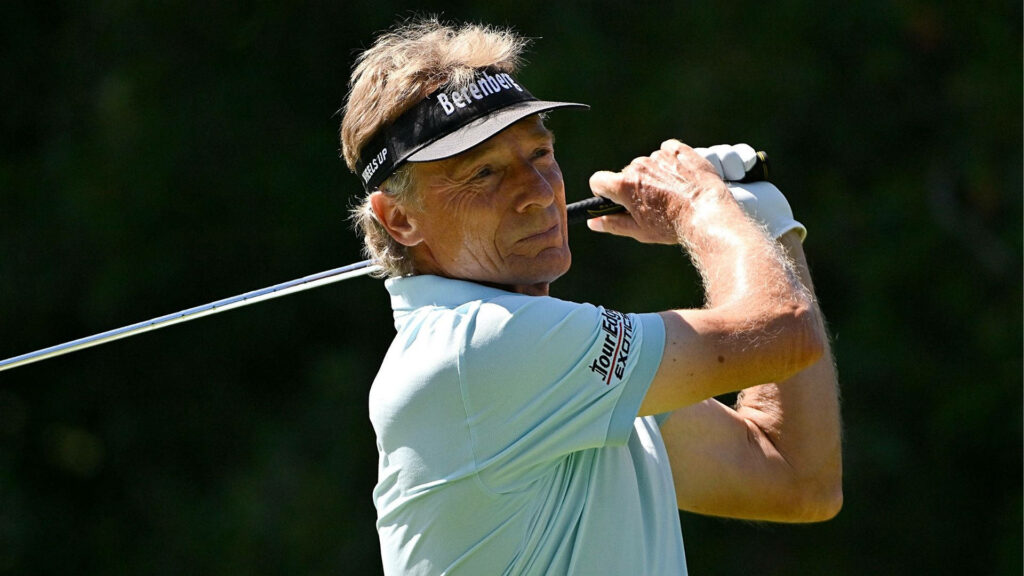 Bernhard Langer focused golf swing dark background legendary golfer wallpaper image