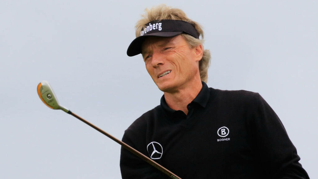 Bernhard Langer mid swing golf wallpaper smooth gray background focused classic attire