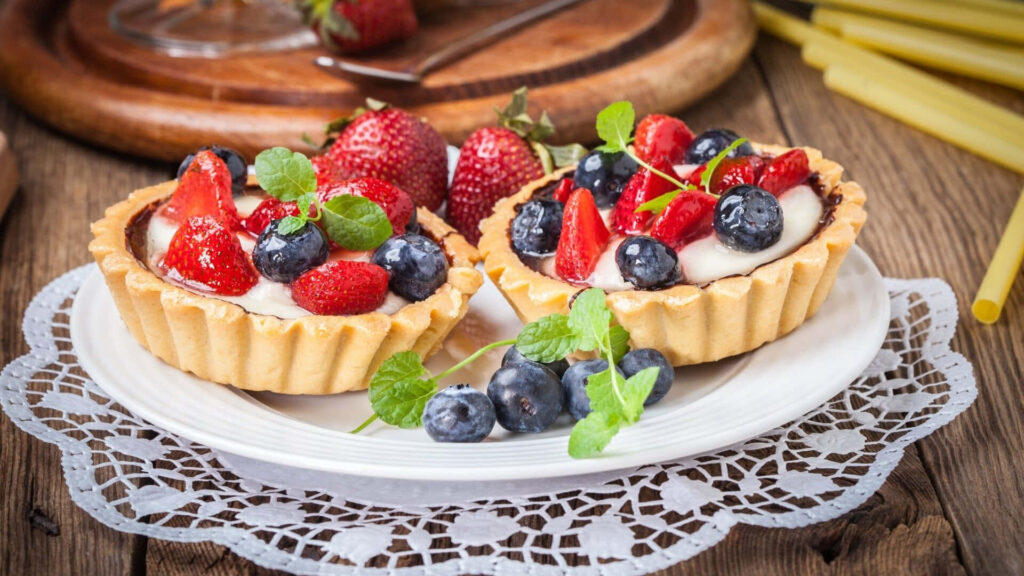 Delicious Delights: Scrumptious Berry Tart on a Rustic Wooden Table Wallpaper