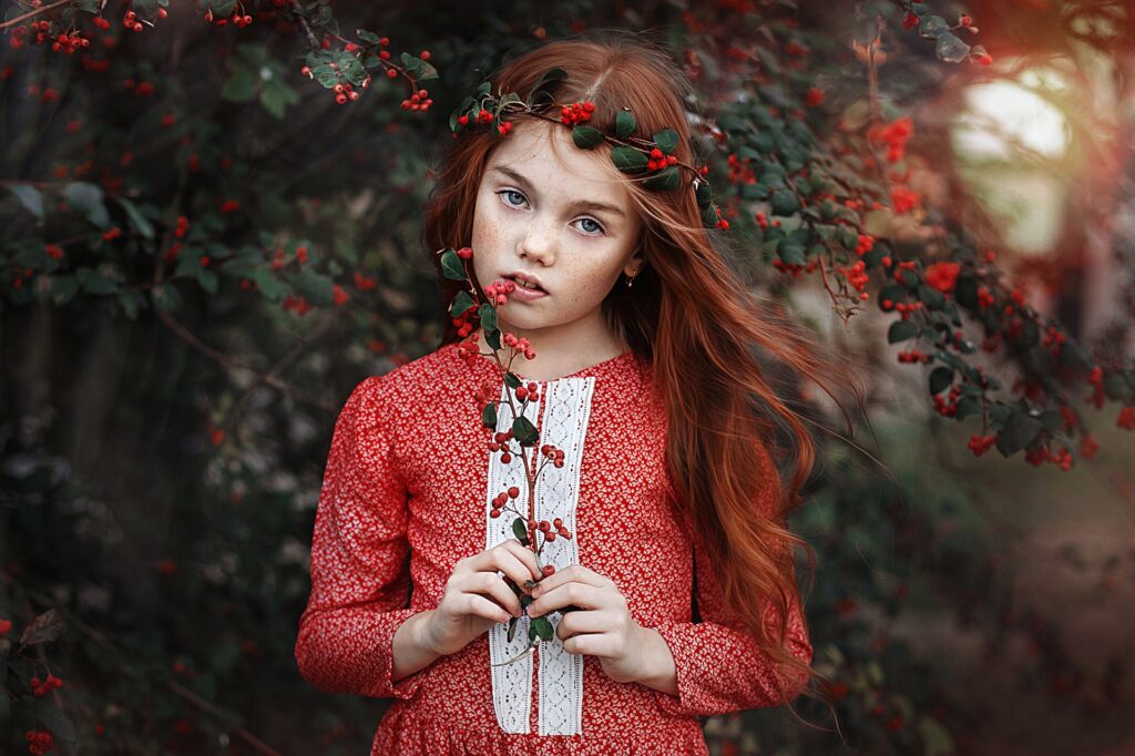 Freckled Beauty in a Berry Wonderland: HD Wallpaper of a Little Redhead Girl with Blue Eyes Captured in Perfect Depth of Field