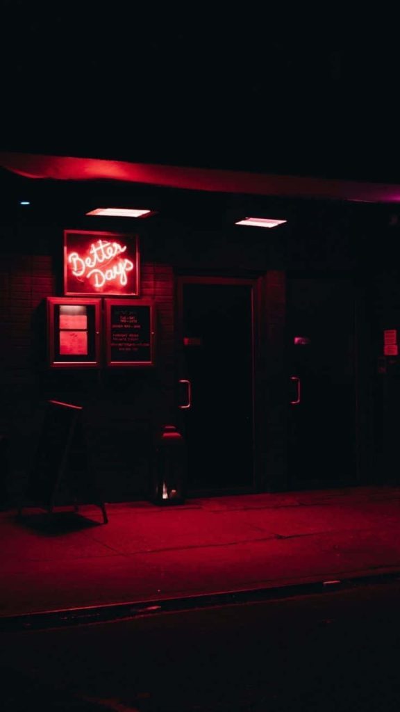 Better Days neon sign glowing red on dark urban wall moody cinematic nightlife wallpaper background