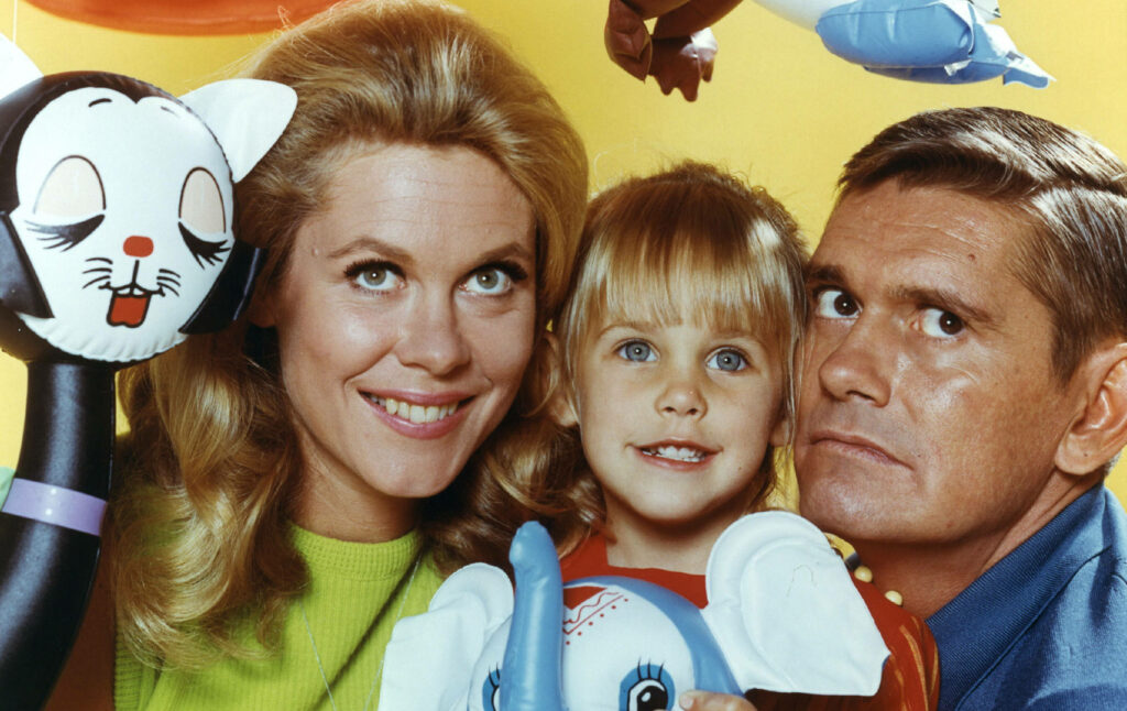 Bewitched family wallpaper with Darrin Samantha and Tabitha smiling bright yellow background toys