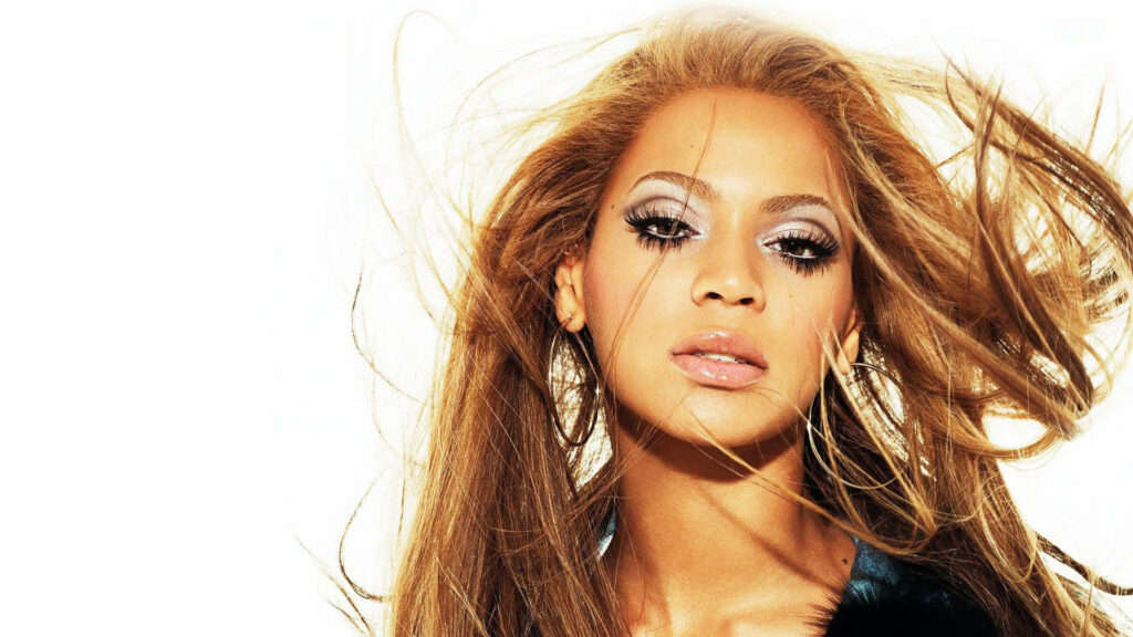 Beyoncé's Elegant Charm: Stunning Hair Flowing Wallpaper Background