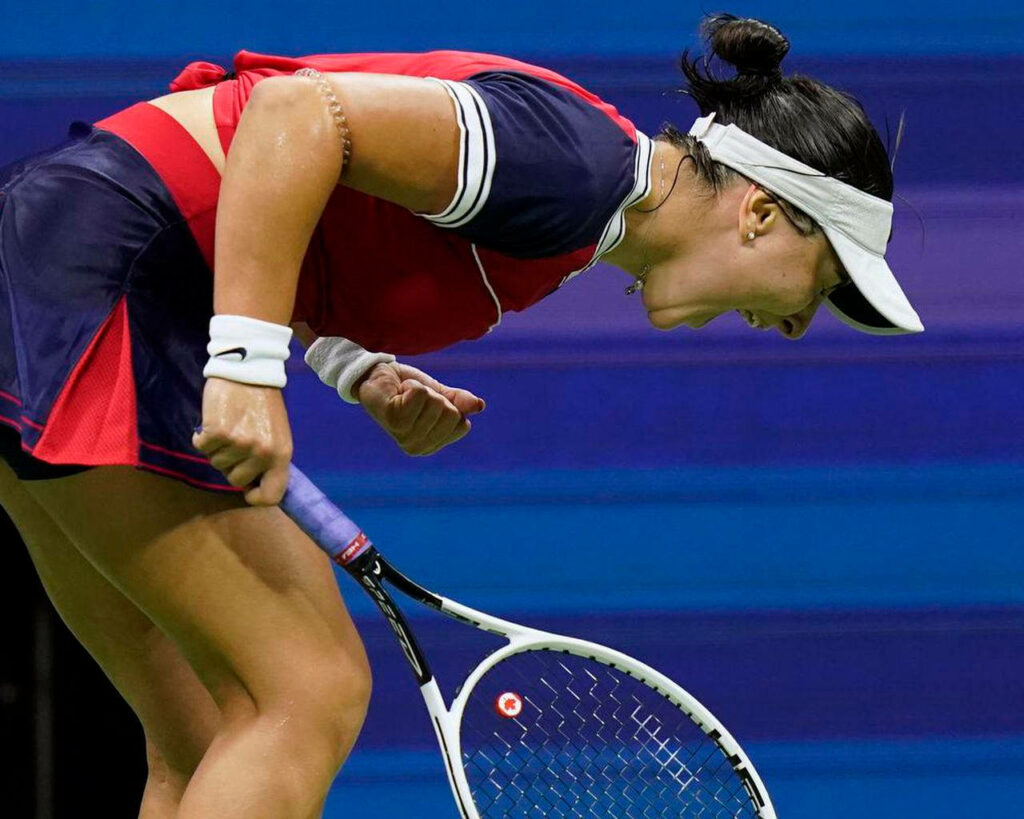 Bianca Andreescu shouting with fierce determination during intense tennis match wallpaper background