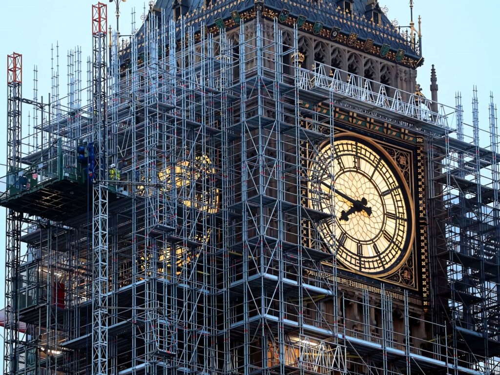 Big Ben clock face surrounded by scaffolding during restoration historic London landmark wallpaper